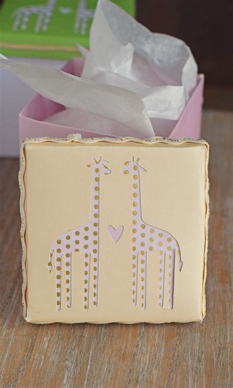 This is how they are putting those cute personalized sayings on baby clothes! Giraffe Baby Shower Gift Boxes with Cricut