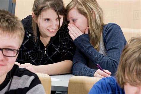 Two female high school students whispering in class - Stock Photo ...