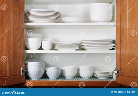 New White Dishes And Bowls In Kitchen Cabinet Stock Image Image 25804801