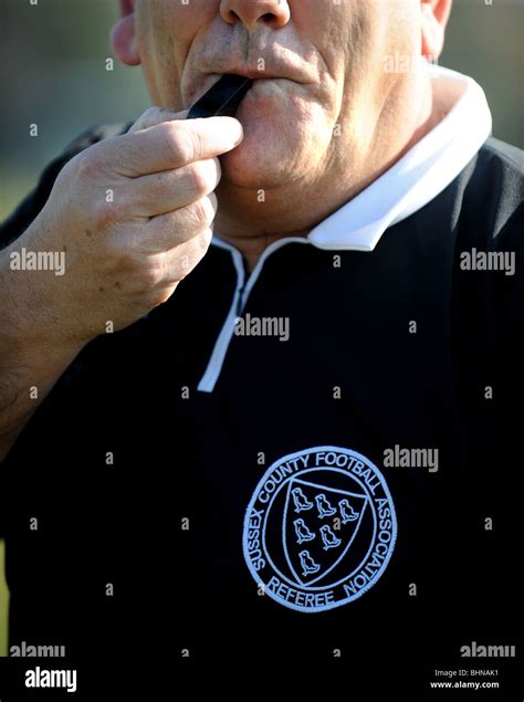 Football Referee Blowing Whistle Stock Photo Alamy