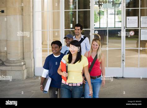 University Students Leaving A Classroom Building On Campus Stock Photo