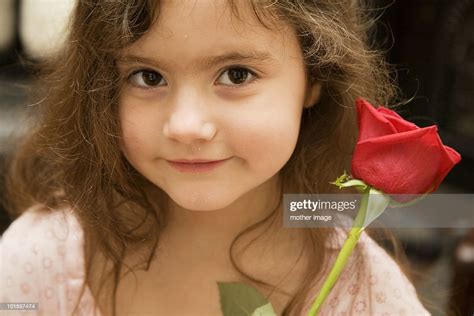 Little Girl Holding Red Rose High Res Stock Photo Getty Images