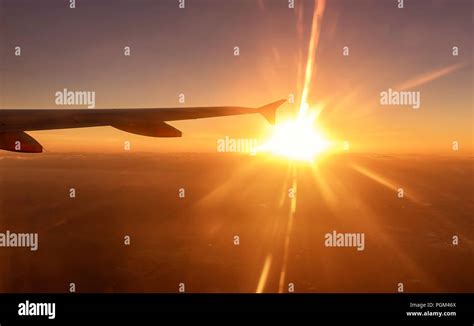 Airplane Wing In The Sunset Stock Photo Alamy