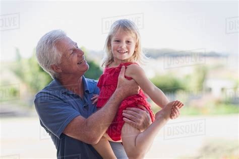 Grandfather Holding Granddaughter Stock Photo Dissolve