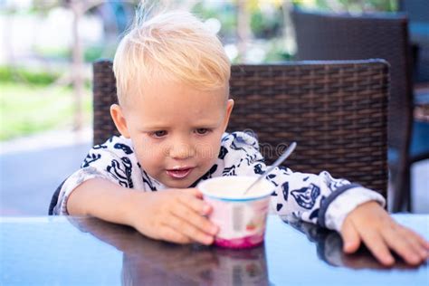 Baby Eating Kids Food Little Boy Eating Yogurt Have A Breakfast In
