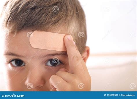 Little Boy With Adhesive Bandage On Indoors Closeup Stock Image