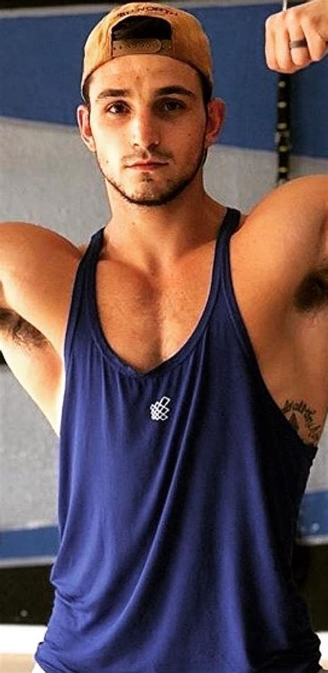Muscular Man In Blue Tank Top Flexing His Muscles