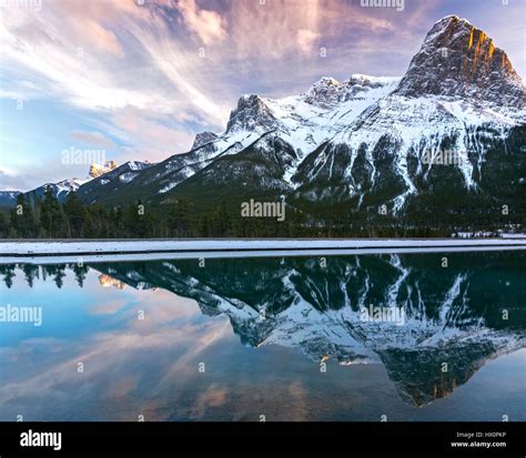Snowy Rocky Mountain Tops And Sunset Landscape Reflections Above Town