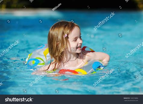 Pretty Little Girl Swimming In Outdoor Pool Stock Photo 104574866