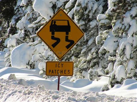 Icy Patches Road Warning Sign On Ice And Deep Snow Stock Photo Image