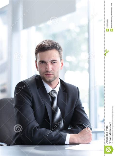 Portrait Of Confident Businessman Sitting Behind A Desk Stock Image