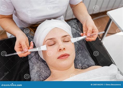 Beautician Applying Clay Face Mask On Woman Face Beautician Working