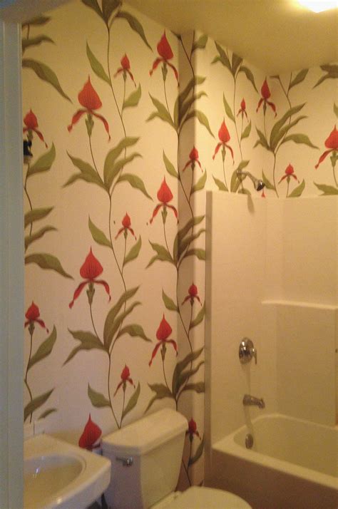 Lovely vibrant floral wallpaper livens up this small bathroom - this is