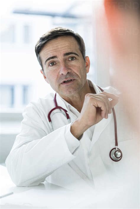 Portrait Of Doctor Talking To Patient In Medical Practice Stock Photo