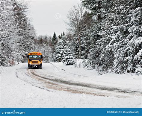 School Bus Driving Down A Snow Covered Rural Road 1 Stock Photo