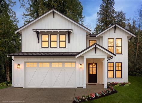 Automatic garage doors with windows. Modern farmhouse exterior with black windows and Clopay ...