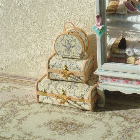 There Is A Small Doll House Set Up On The Floor In Front Of A Dresser