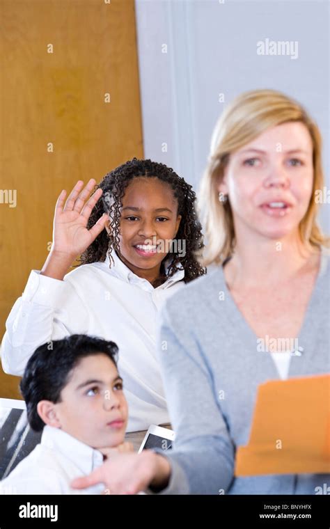 African American Girl Student Raising Hand In Class Stock Photo Alamy