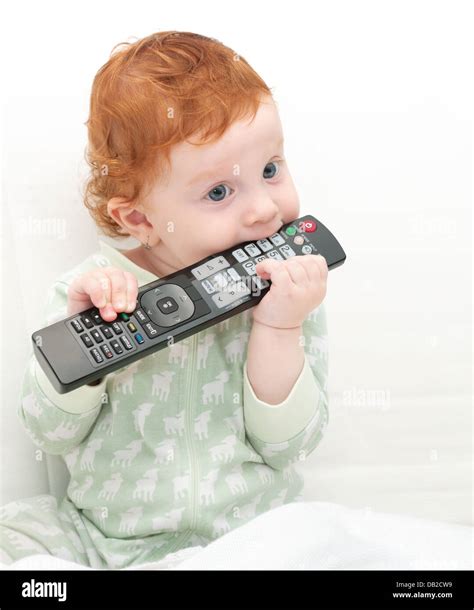 Toddler Baby Watching Tv Holding Remote Control Stock Photo Alamy