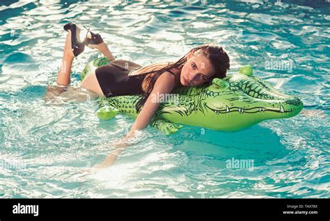 Girl On Inflatable Mattress Crocodile In The Pool Stock Photo Alamy