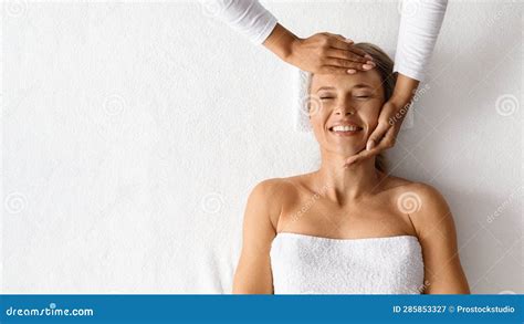 Female Therapist Making Face Lifting Massage For Beautiful Woman At Spa Salon Stock Image