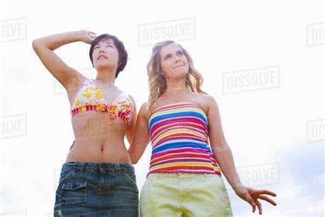 Women Standing Together Outdoors Stock Photo Dissolve