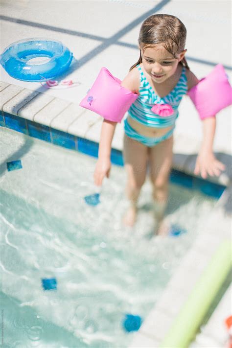 Young Girl Steps Into The Pool By Stocksy Contributor Skc Stocksy