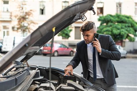 Free Photo Young Business Man Trying To Fix His Car