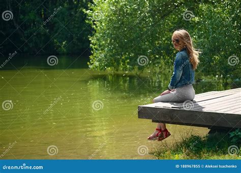 Side View Of Dreaming Girl Sitting On Wooden Pier On River Bank Stock Image Image Of Outdoor