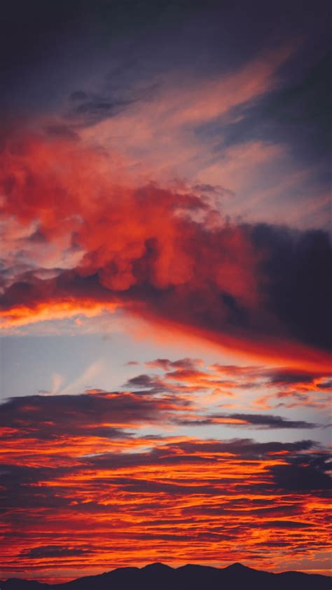 Download Wallpaper 800x1420 Clouds Sky Sunset Red Porous Mountains