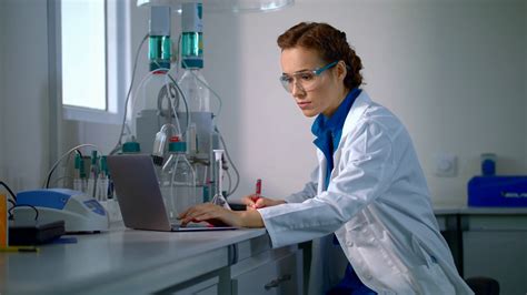 Scientist Find A Cure Woman Scientist Looking At Chemical Liquid In Lab Flask Female Scientist