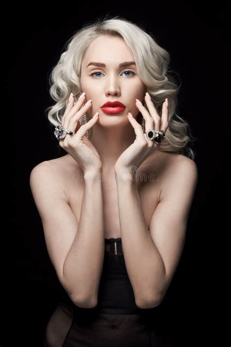 beauty fashion woman with jewelry on her hands wavy hair portrait of a blonde girl with rings