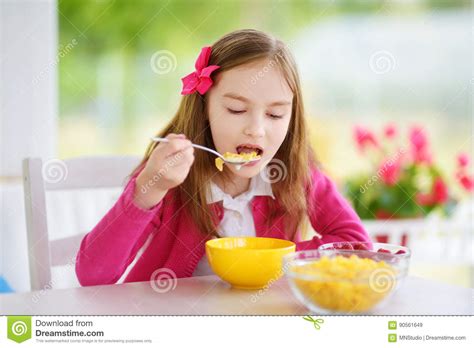 Cute Little Girl Enjoying Her Breakfast At Home Pretty