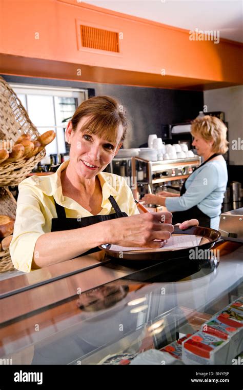 Waitress In Restaurant Behind Counter With Order Stock Photo Alamy