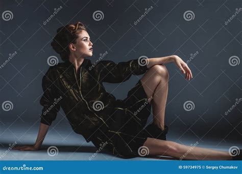 Fashion Woman Sitting On The Floor In An Elegant Pose Stock Image
