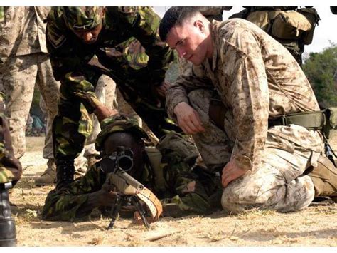 Us Marine Helps A Member Of The Kenyan Army Assume The