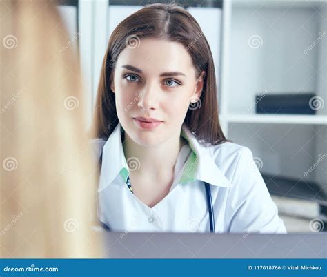 Young Female Doctor Giving A Consultation To A Patient And Explaining