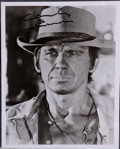 An Old Black And White Photo Of A Man Wearing A Cowboy Hat With His