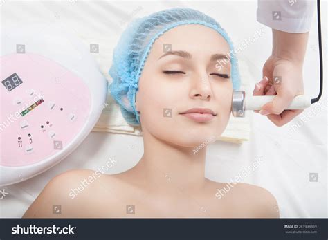 Woman Getting Ultrasound Skin Cleaning At Beauty Salon
