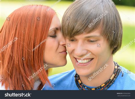 Loving Young Woman Kissing Boyfriends Cheek Stock Photo 203562826
