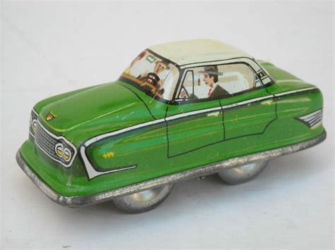 This all tin friction car has rubber wheels and a black and. Vintage Tin Litho, Made In West Germany Wind-Up Toy Car ...