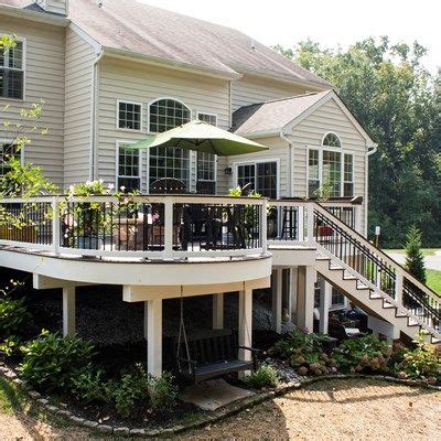 Backyard landscapes need to be functional as spaces that are useful as well as beautiful. An elevated deck with curved design uses dark and light ...