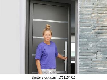 Man Opening Door Her Homeinviting Guests Stock Photo
