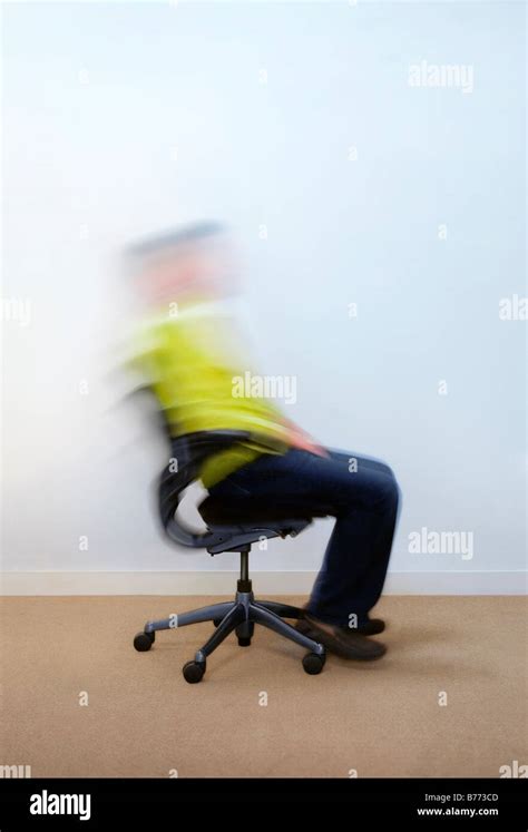 Man Rocking Back And Forth On Office Chair Stock Photo Alamy