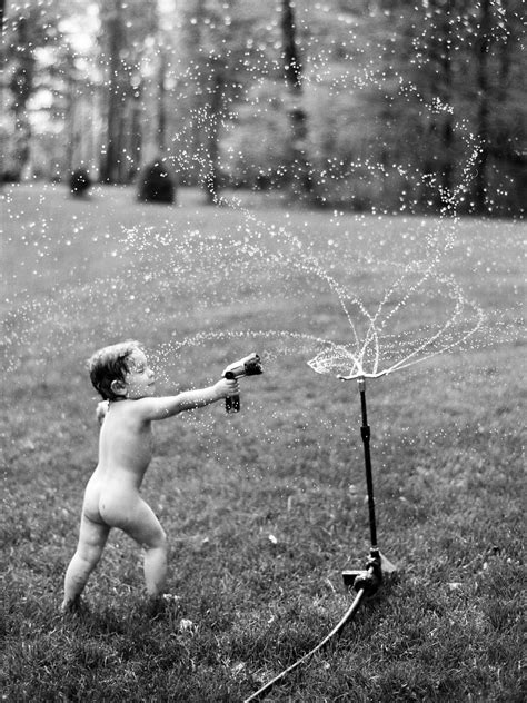 A Small Naked Boy Plays In A Sprinkler During The Summer By Stocksy Contributor Dave Waddell