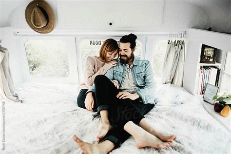 Cute Hipster Couple Cuddling In Converted School Bus Tiny Home By Brett