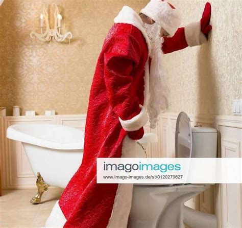 funny drunk santa claus peeing in the toilet model released symbolfoto