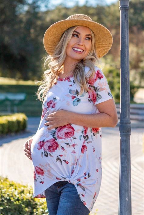 Floral Printed Maternity Top Featuring A Rounded Neckline Short Sleeves And A Knot Accent On