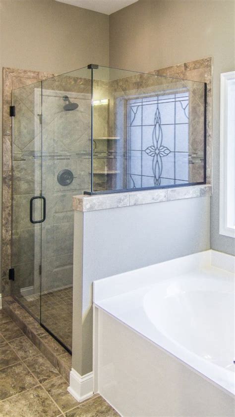 Regardless, there *must* be a drawable curtain of some kind and good he suggested that we use the glass so we can sit in the tub and watch tv! Glass surround & half wall | Half walls, Bathtub, Master bath