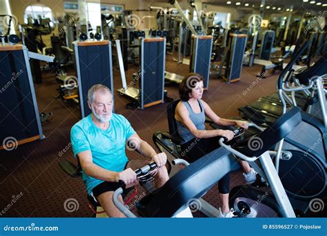 Beautiful Fit Senior Couple In Gym Doing Cardio Work Out Stock Image